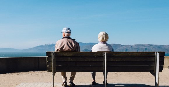 Two Older People on Bench viewing mountains